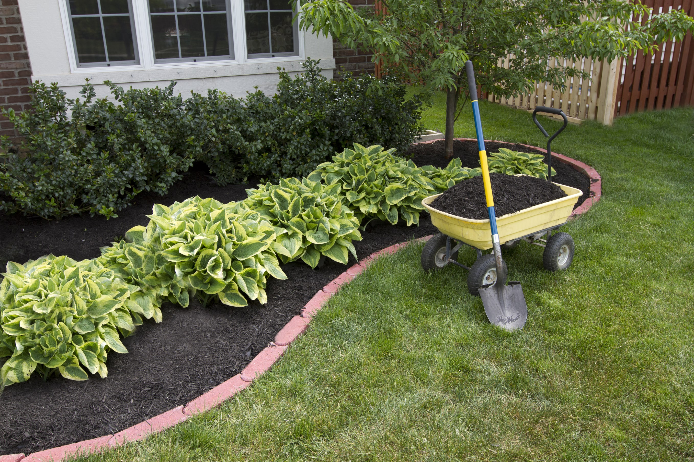 adding mulch to a flower bed