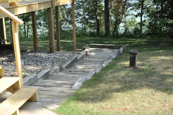 Wooden steps going down a grassy hill